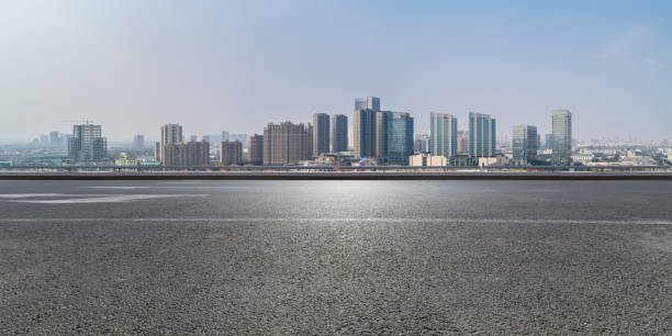istock Panoramic skyline and modern business office buildings with empty road,empty concrete square floor 971919494