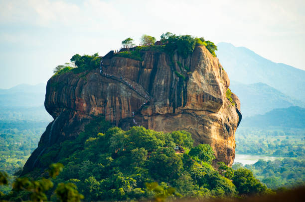 spectacular view of the lion rock surrounded by green rich vegetation. picture taken from pidurangala rock in sigiriya, sri lanka. - buddhism sigiriya old famous place imagens e fotografias de stock