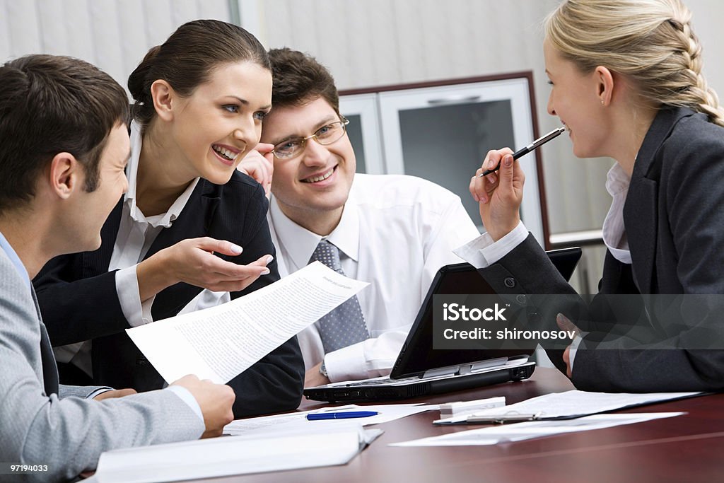 Individuals in business wear having a discussion Portrait of happy business team interacting in the office  Adult Stock Photo