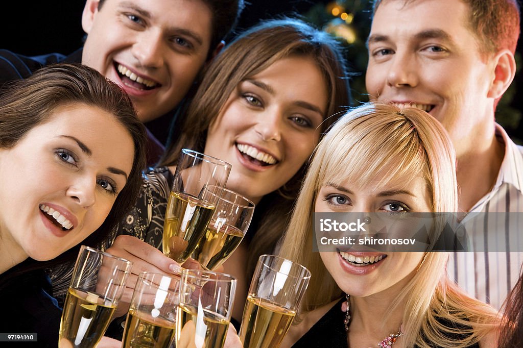 Happy young people cheering with champagne Portrait of smiling people holding cocktails and looking at camera  Adult Stock Photo