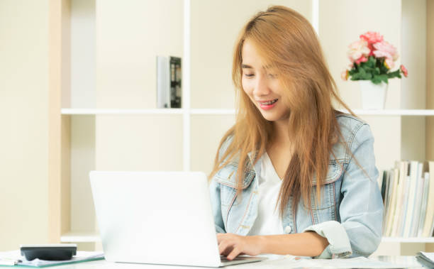 istock Happy woman works on computer in home office. 971942844