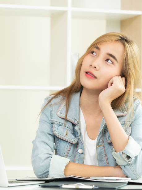 istock Creative woman thinking or planning in the office. 971942860