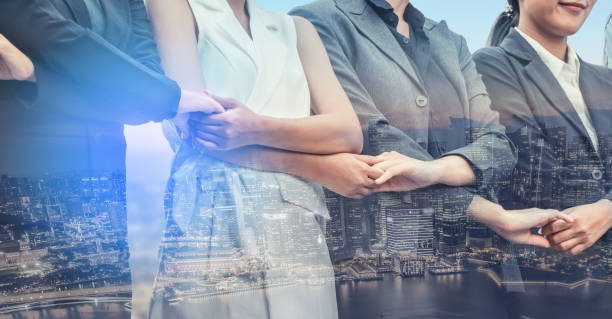 istock Double exposure business people holding hands. 971949558