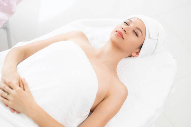 istock Relaxed young woman lying on spa bed for massage. 971952750