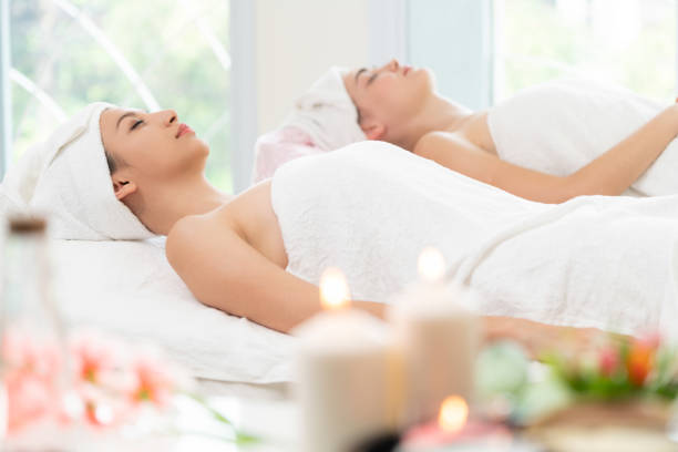 istock Relaxed young woman lying on spa bed for massage. 971952752