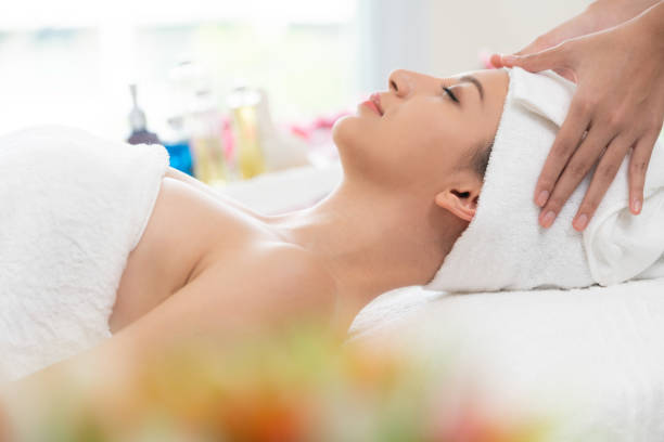 istock Relaxed young woman lying on spa bed for massage. 971952762