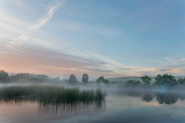 Sunrise over the river and forest.