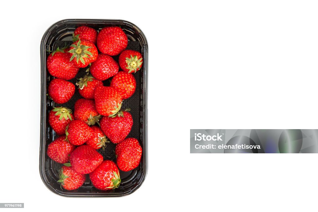 ripe strawberry in black container on white background juicy ripe strawberry in supermarket box on white background Plastic Container Stock Photo