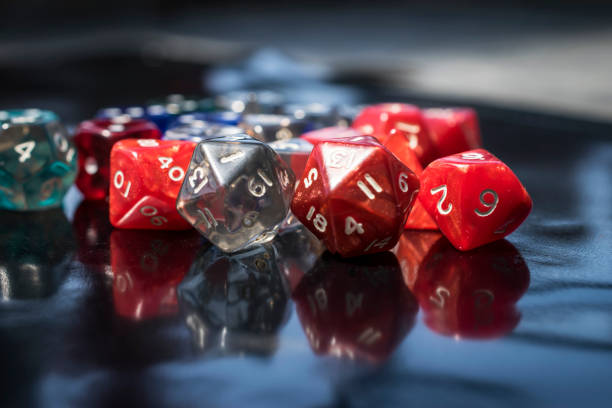 A set of colorful RPG dice A set of colorful RPG dice on a black table developing 8 stock pictures, royalty-free photos & images