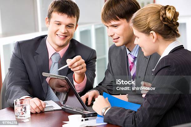 Business People Working Together In Front Of A Laptop Stock Photo - Download Image Now