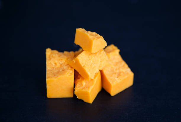 istock Cheese in peaces on the black background 971963764