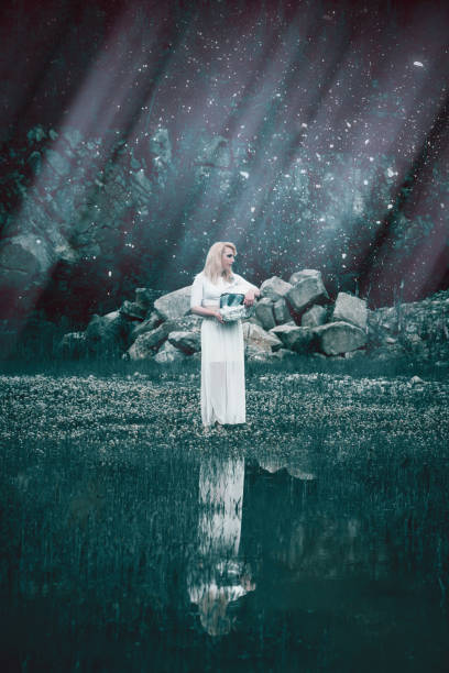 istock Young blond woman in white reflected in a lake 971963864