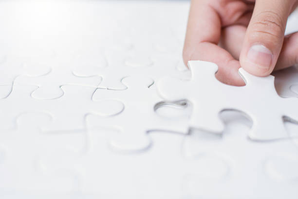 istock Close up girl's hand playing  jigsaw 971963868