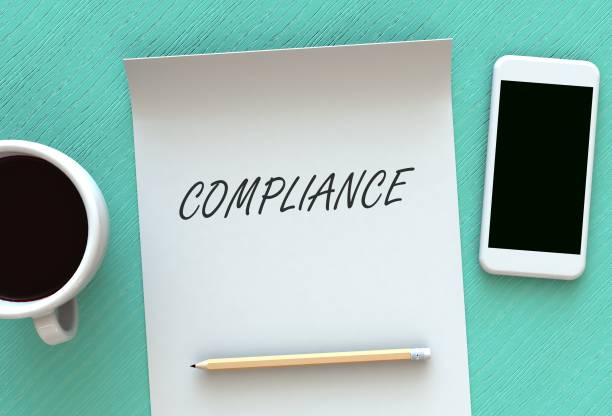 istock COMPLIANCE, message on paper, smart phone and coffee on table, 3D rendering 971963888