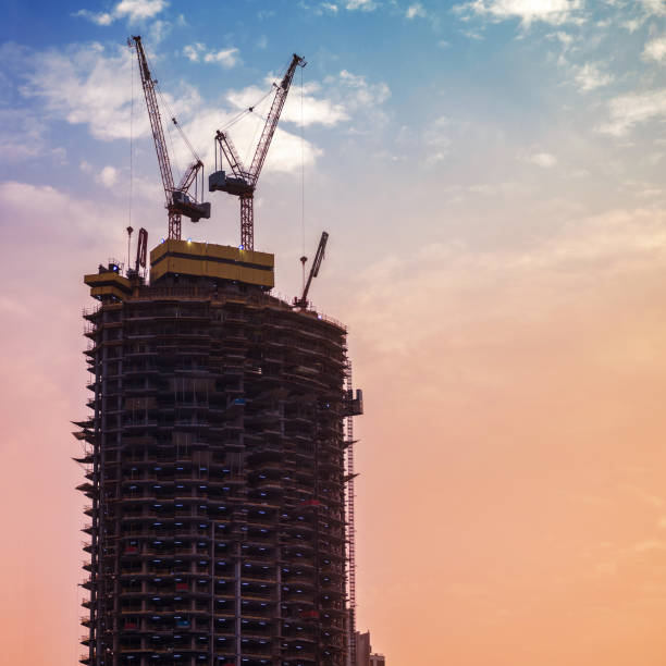 istock Construction of high-rise building. Construction cranes and skyscraper 971963948
