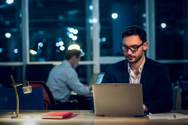 istock Young businessman staying up late working 971970276