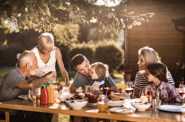 istock Happy multi-generation family enjoying in lunch time at their back yard. 971977574