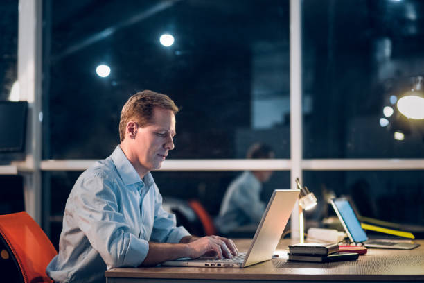 istock Businessman working with computer late at night 971977878