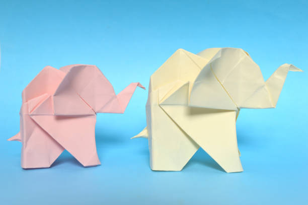 istock Pink and yellow origami elephant 971989380