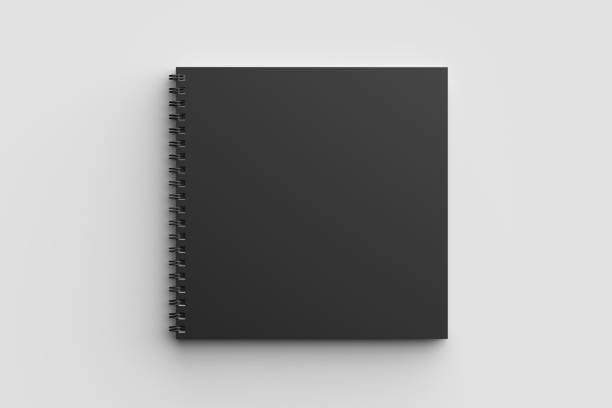 istock Spiral binder square notebook mock up with black cover isolated on soft gray background. 3D illustration. 971990214