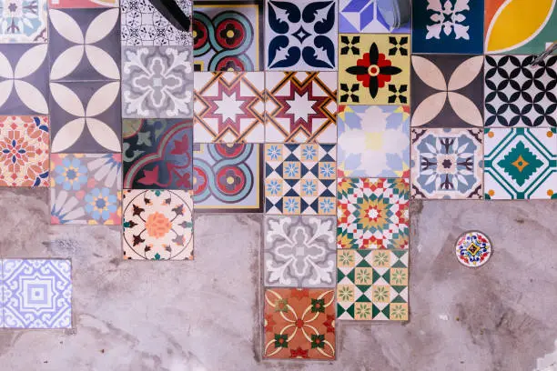 Various of type and color floor square tiles with concrete floor.