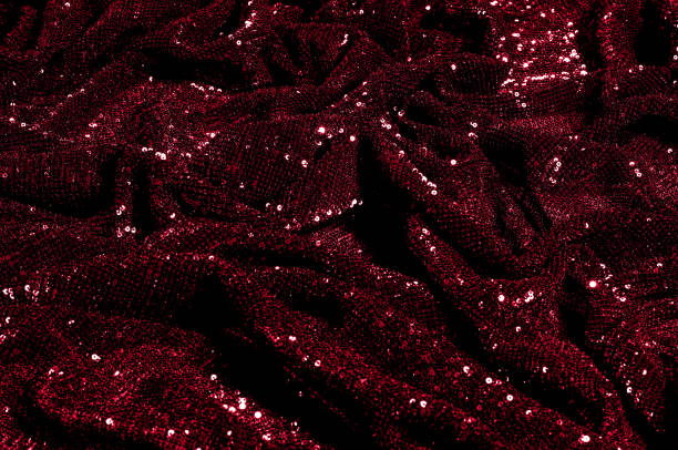 istock Texture, background, pattern, red fabric with paillettes. Look at these neon red sequins. Round neon pink sparkles glitter overlapping iridescent glitter on a clean purple grid. 971998520