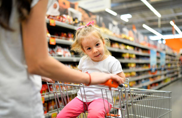 istock A quick mom with a daughter in a supermarket 972007180