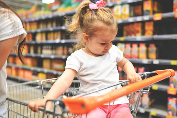 istock Child Having Arguement With Mother At Candy Counter 972007228