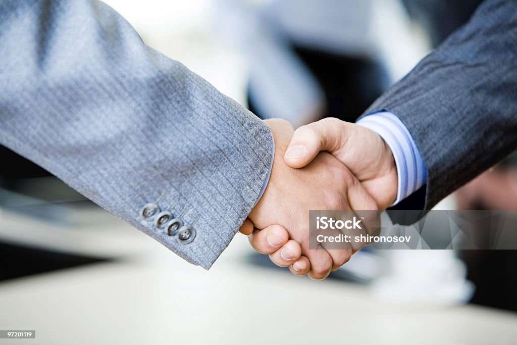 Two businessmen engaging in a handshake  Adult Stock Photo