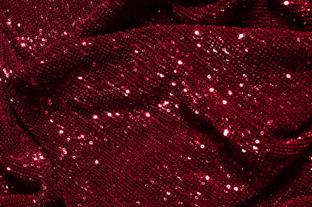 istock Texture, background, pattern, red fabric with paillettes. Look at these neon red sequins. Round neon pink sparkles glitter overlapping iridescent glitter on a clean purple grid. 972020060