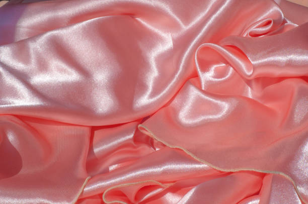 istock Texture, background, pattern. Lining female dress light orange, lining cloth orange. Fabric coral silk 972020124