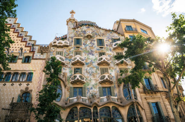 The facade of the house Casa Batllo or House of bones designed by Antoni Gaudi with sunshine at sunset Barcelona, Catalonia, Spain - May 30 ,2016: The facade of the house Casa Batllo or House of bones designed by Antoni Gaudi with sunshine at sunset casa stock pictures, royalty-free photos & images