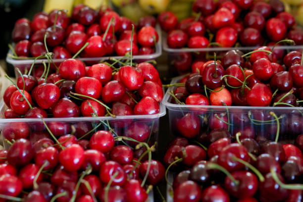 istock Fresh red cherry in the plastic box ready for sell in the fruit market. 972026708