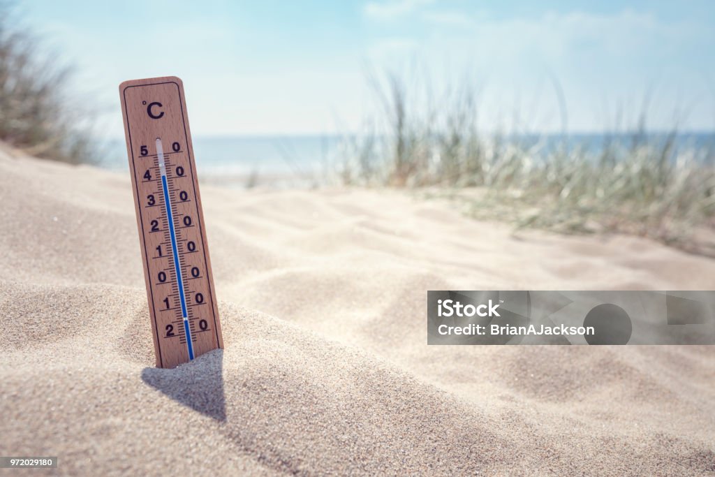 Thermometer on the beach background Thermometer on the beach showing high temperature  background Heat Wave Stock Photo