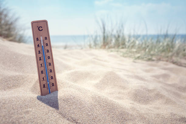 Thermometer on the beach background Thermometer on the beach showing high temperature  background heat wave photos stock pictures, royalty-free photos & images