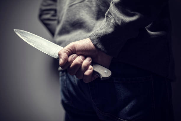 Knife crime Criminal with knife weapon hidden behind his back revenge photos stock pictures, royalty-free photos & images