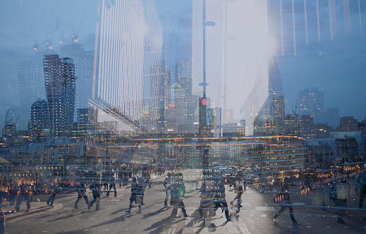 Multiple exposure of city commuters crossing a street and skyscrapers of the City of London