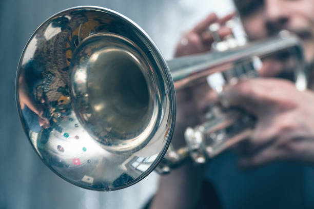 istock Trumpeter is playing on a silver trumpet 972047622