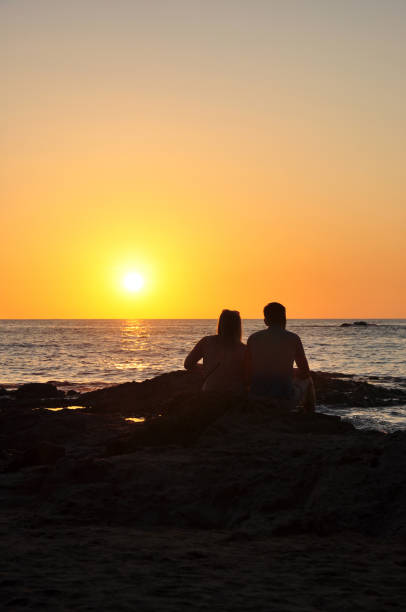 istock Couple tourists looking sunset 972066932