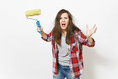 Young crazy loony woman in casual clothes holding paint roller for wall painting and screaming isolated on white background. Instruments, tools for renovation apartment room. Repair home concept.