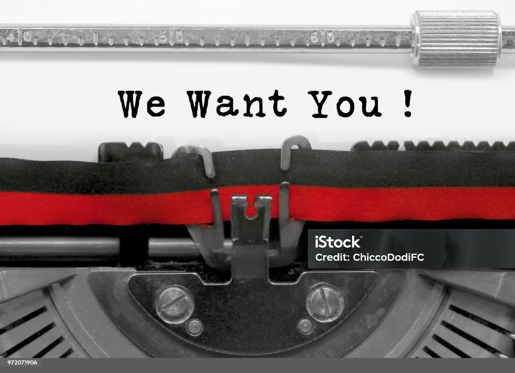 We want you text by the old typewriter on white paper We want you text written by an old typewriter on white sheet Audition Stock Photo