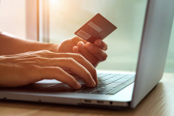 istock Online shopping concept. Hands holding credit card and using laptop computer. 972074154
