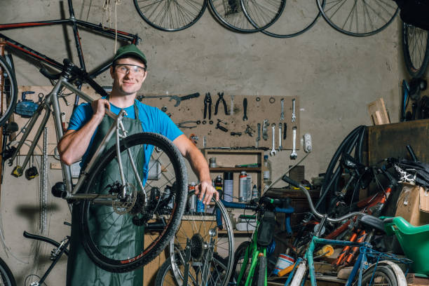 istock Competent bicycle mechanic in a workshop repairs a bike. 972074430