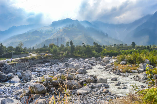 istock World environment day concept. Dramatic valley sky sunset time panoramic landscape background. Landscape Nature background concept. Daylight falls in valley with dark clouds and blue sky. 972074824