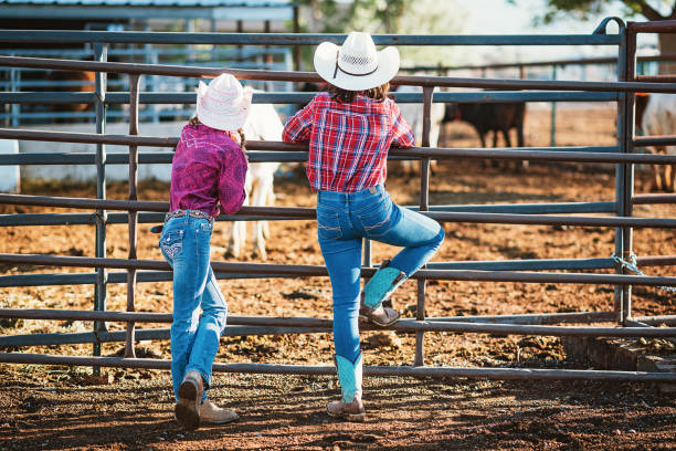 istock Young sisters with hats on the ranch 972076986