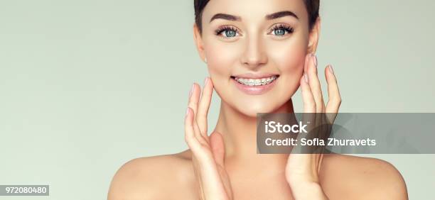 Young Attractive Model Is Smiling Wide And Shows Teeth Braces Dental Health Stomatology And Beauty Technology Stock Photo - Download Image Now