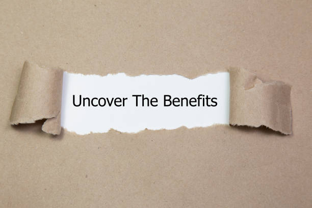 istock Uncover The Benefits written under torn paper. 972086522