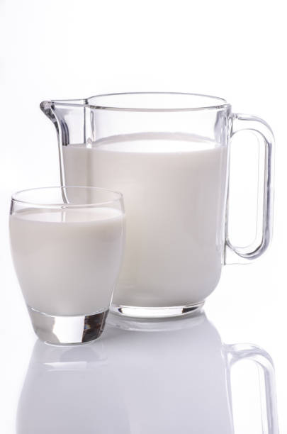 istock cold milk poured into a glass to drink 972086840