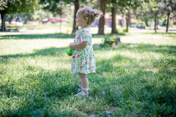 istock baby girl in park. 972089206