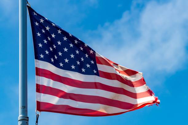 istock the American flag is flying in a strong wind 972098716